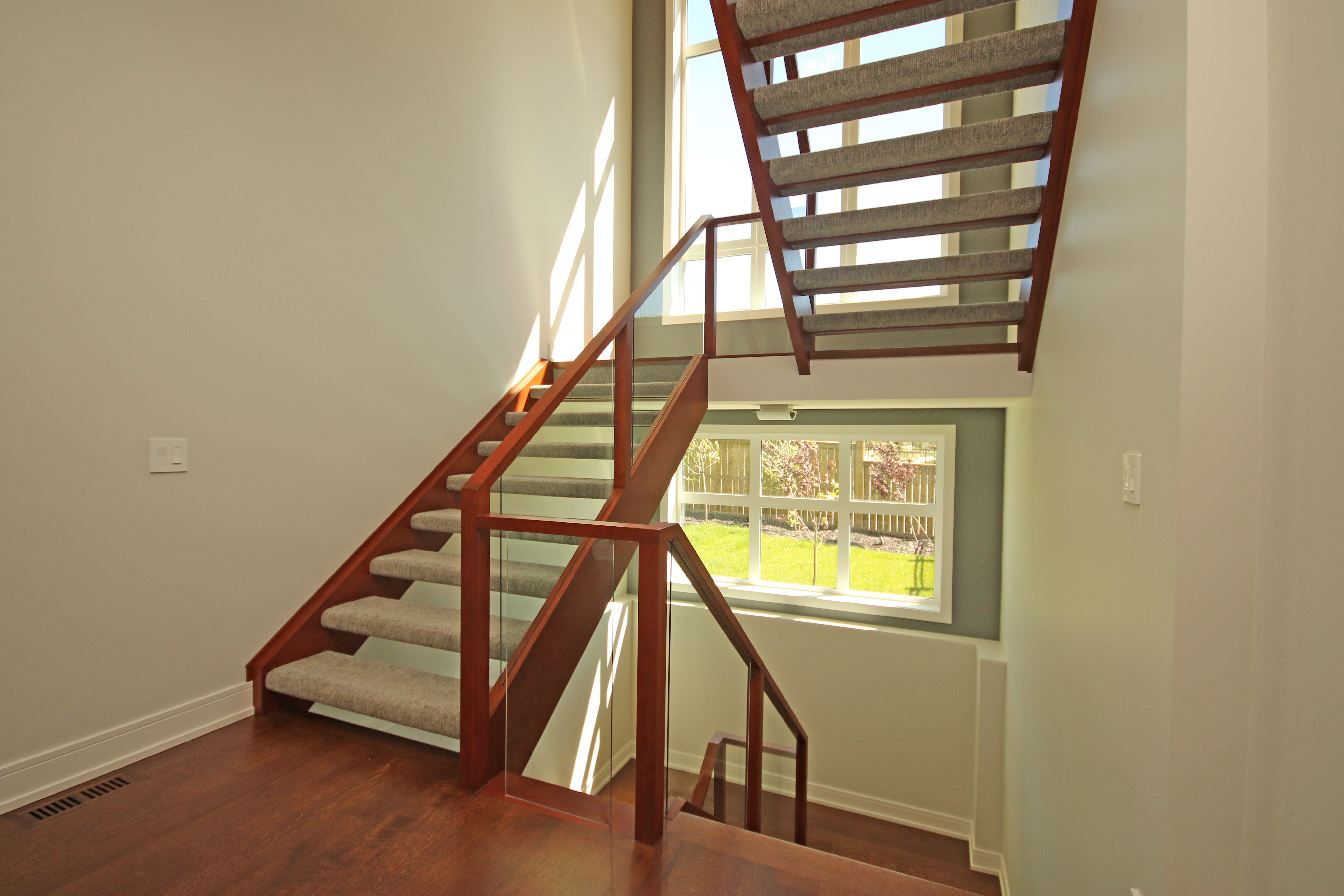 Staircase painting with Teak on fir railing, Paper White walls, Oxford White casings by Johnny B's Painting
